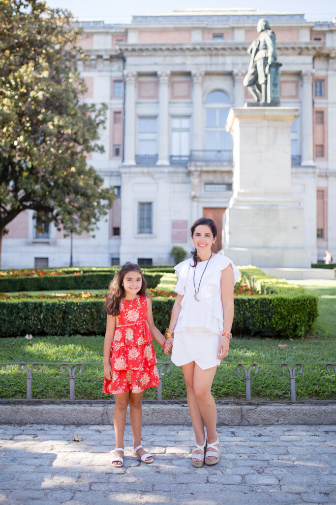 Mother and daughter holding hands in front of the Prado Museum in Madrid