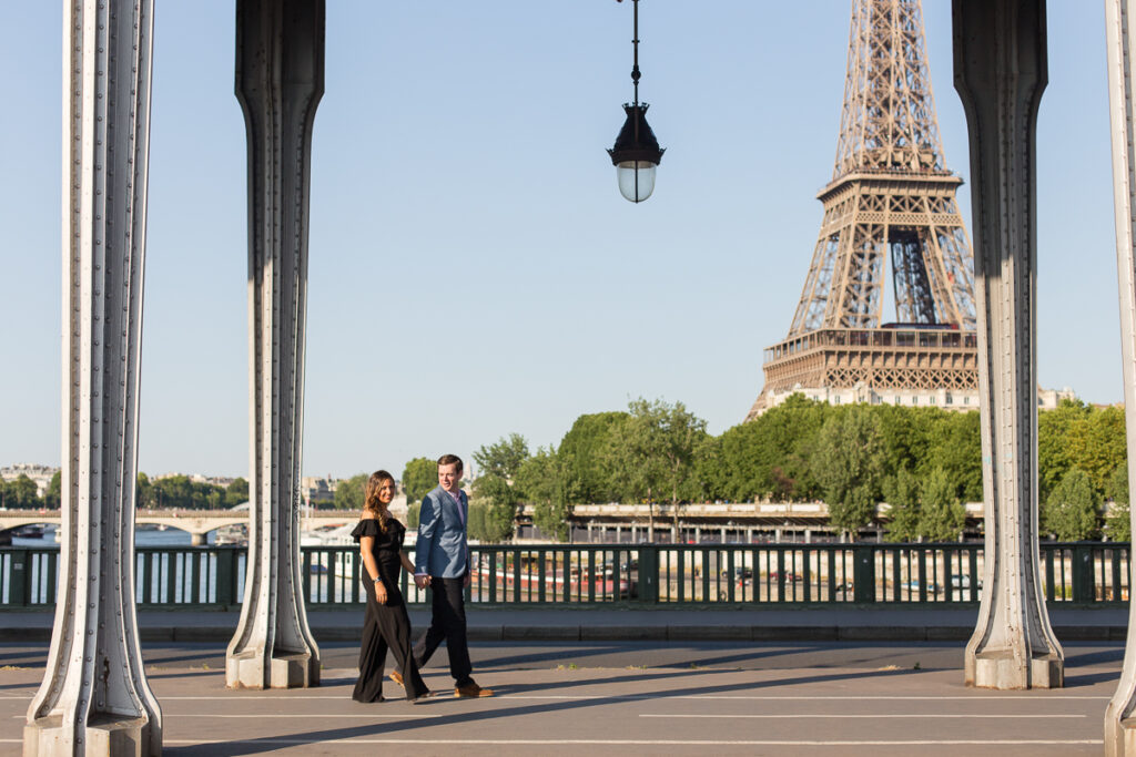 Parents wrapped in a plaid blanket holding their baby during a fall family photoshoot in Paris