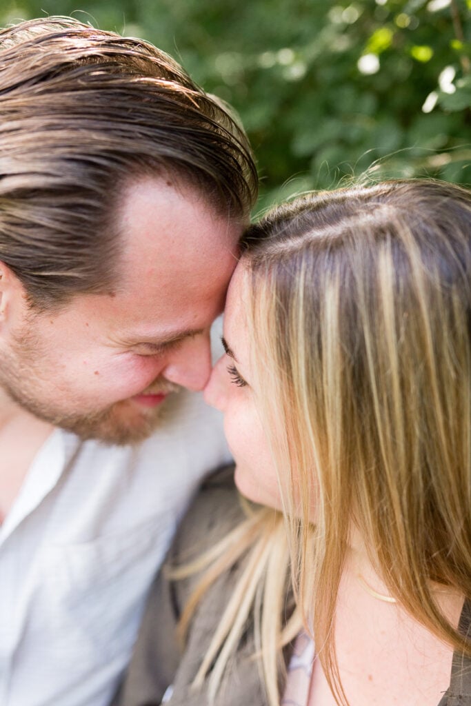 Close-up of a newly engaged couple touching foreheads in Monet's garden