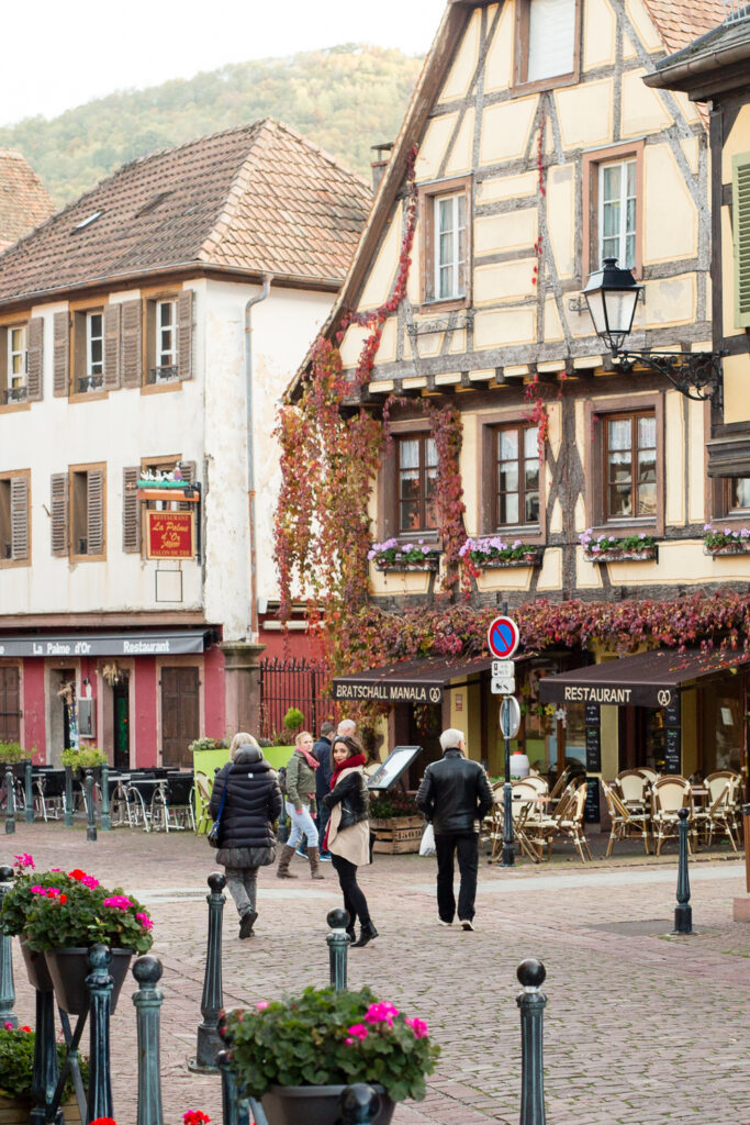 Half-timbered houses and a café terrace in the center of Kaysersberg, Alsace