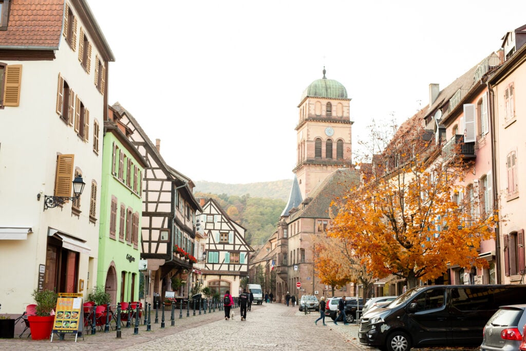 Main street of Kaysersberg with its church tower and fall foliage