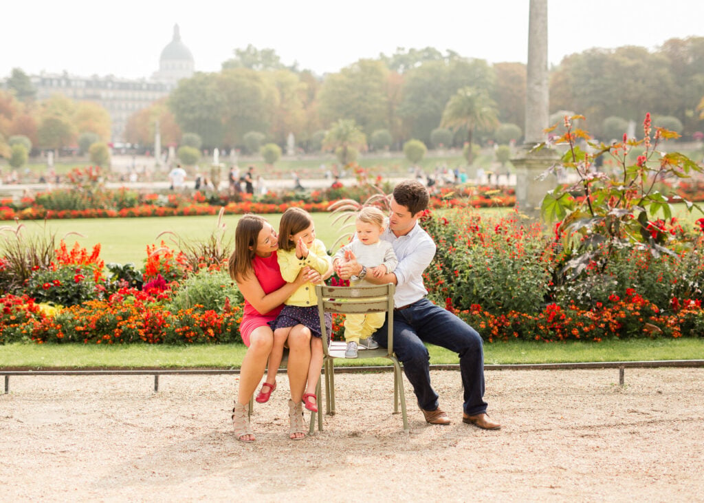 Portrait of family on park bench in Paris in August vacation by Katie Donnelly Photography