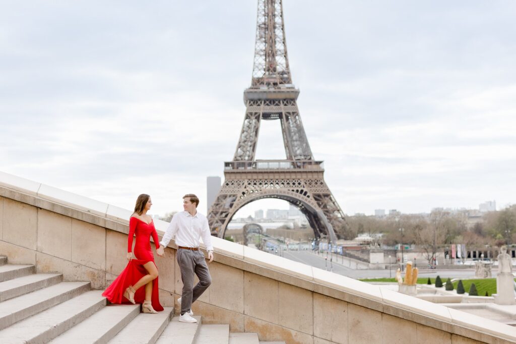 Couple with red dress during a photo shoot at the Eiffel Tower