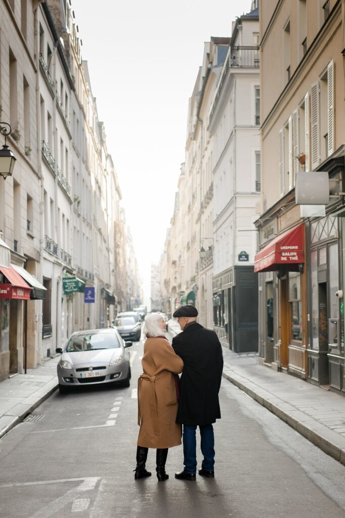 Couple standing together in quiet street in Ile Saint Louis Paris by Katie Donnelly Photography