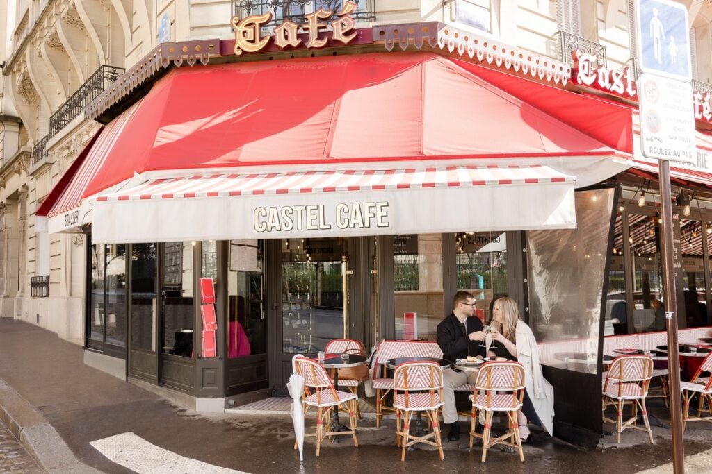 Portrait of couple at Paris cafe on rainy day photoshoot by Katie Donnelly Photography
