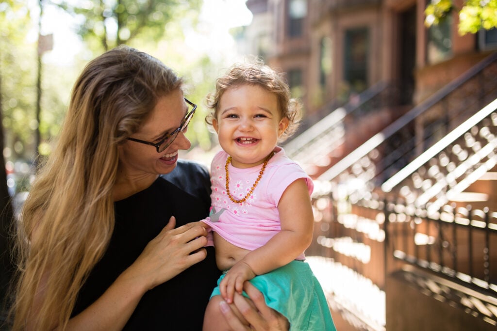 Portrait of mother holding her toddler daughter in Paris: Paris Heat Wave Survival Guide to stay cool in summer by Katie Donnelly Photography