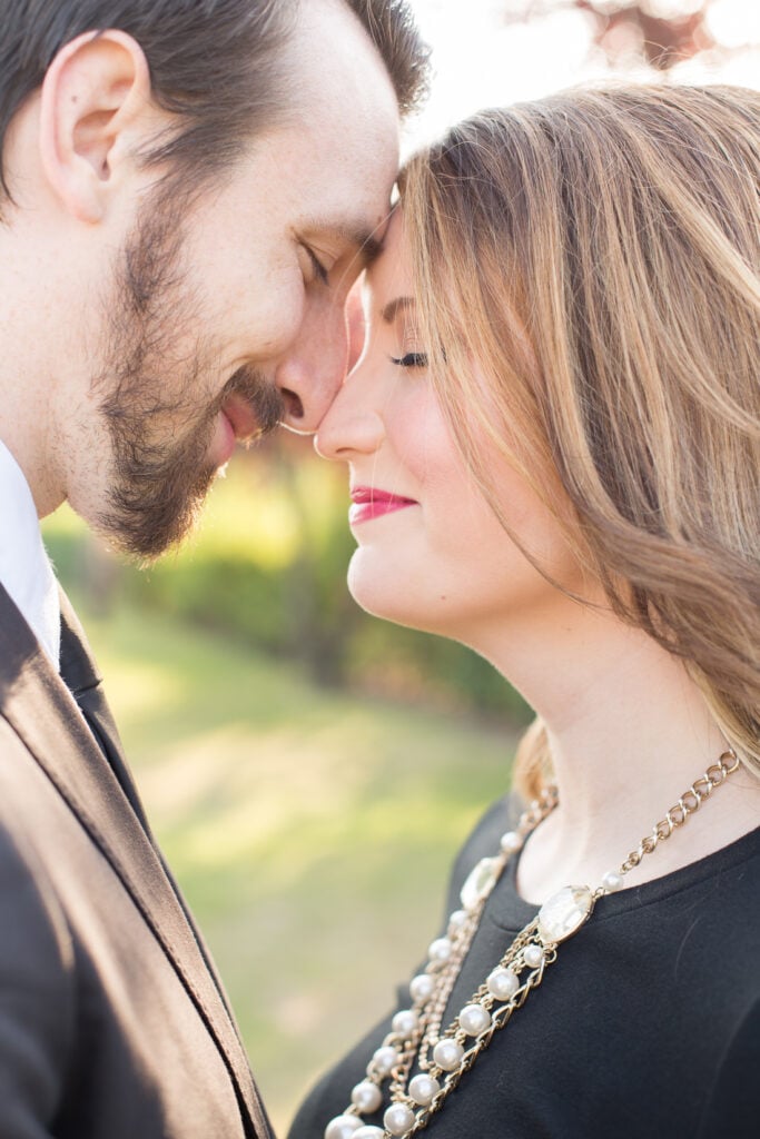 Close-up of a couple touching foreheads in a Paris garden