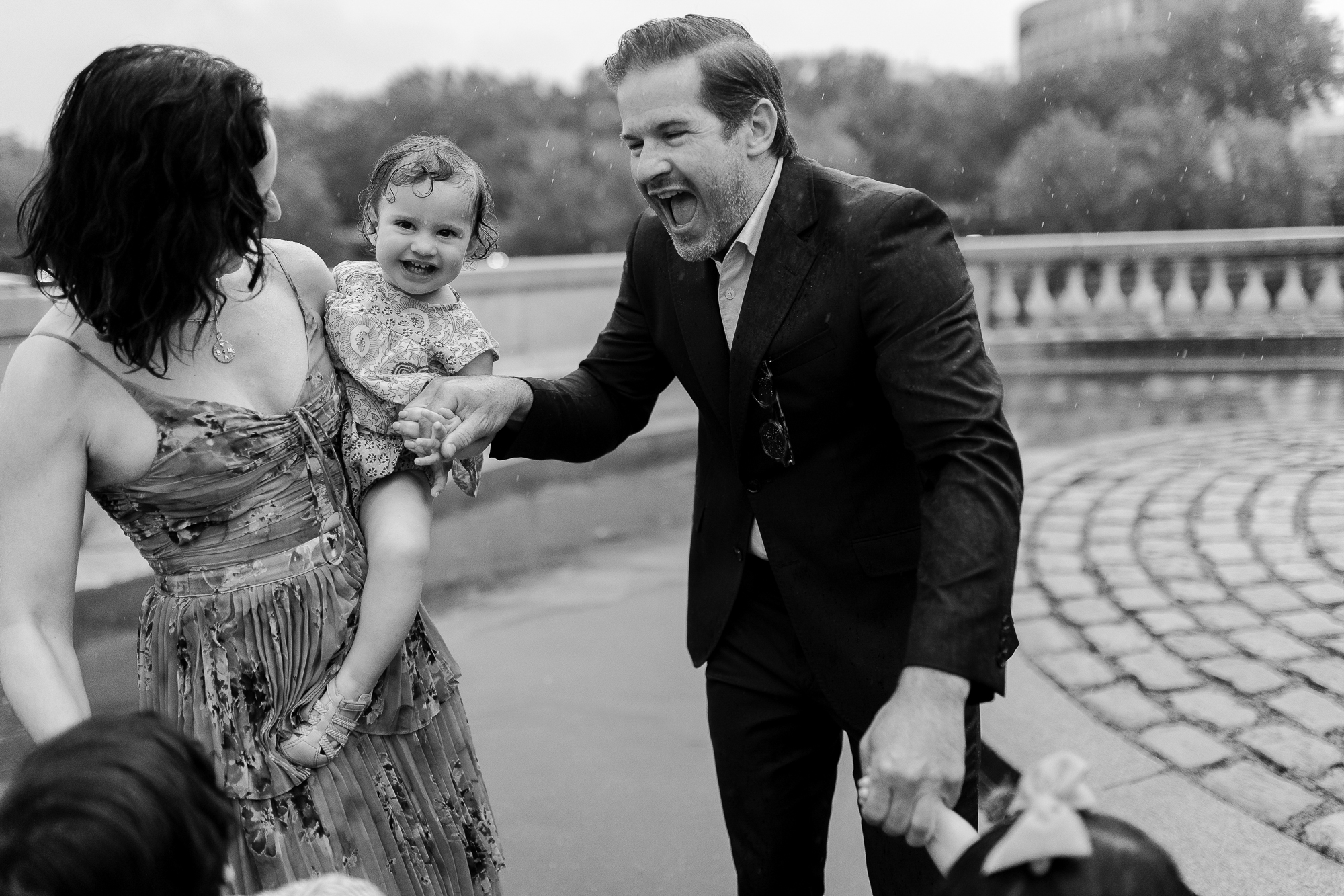 Paris family photographer, candid rainy family photo shoot in Paris at the Eiffel Tower