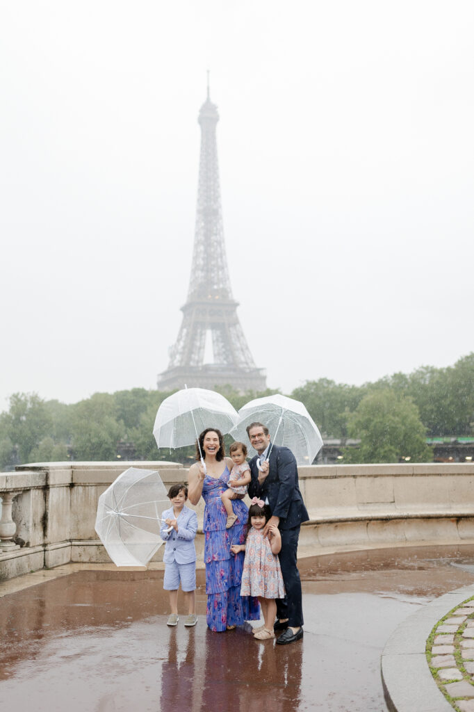 Portrait of family with Eiffel Tower on a rainy day in Paris by Katie Donnelly Photography