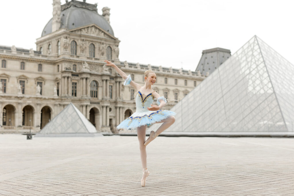 Portrait of young ballerina in front of the Louvre in Paris by Katie Donnelly Photography