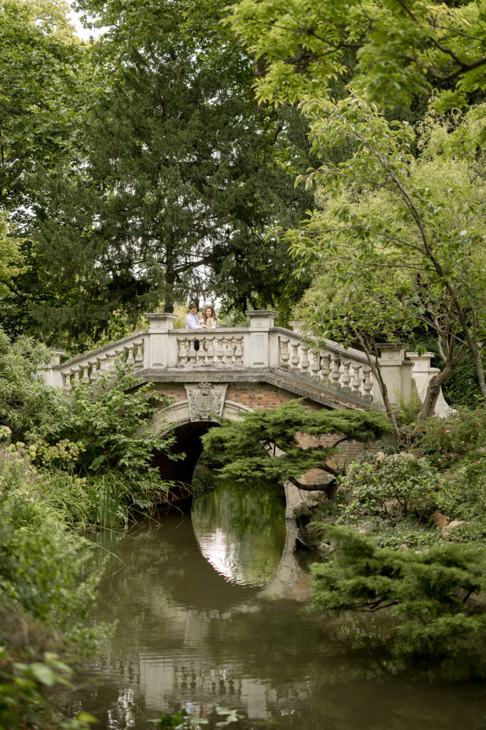 Portrait of young family on bridge over pond at Parc Monceau by Katie Donnelly Photography