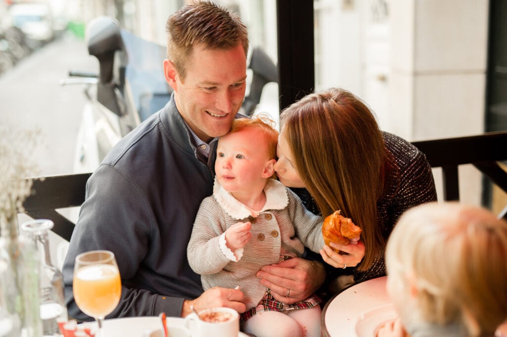 Portrait of parents with young child at restaurant in Paris by Katie Donnelly Photography