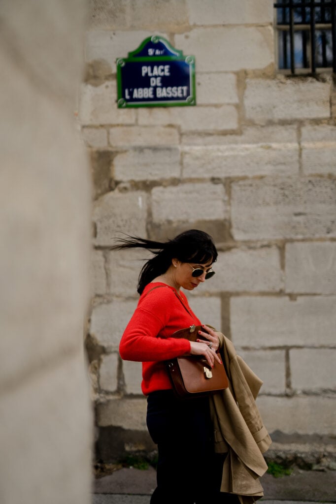 Portrait of woman in Paris street with layered outfit and accessories by Katie Donnelly Photography