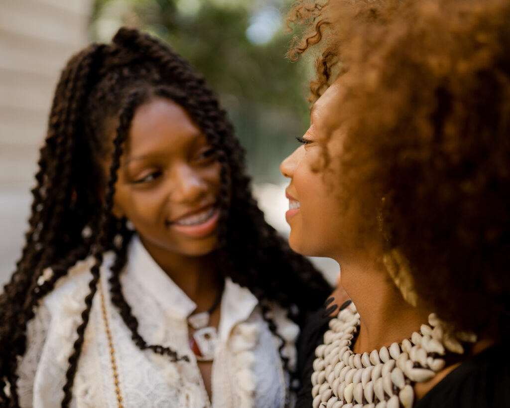 Portrait of mother and daughter smiling at each other in Paris by Katie Donnelly Photography