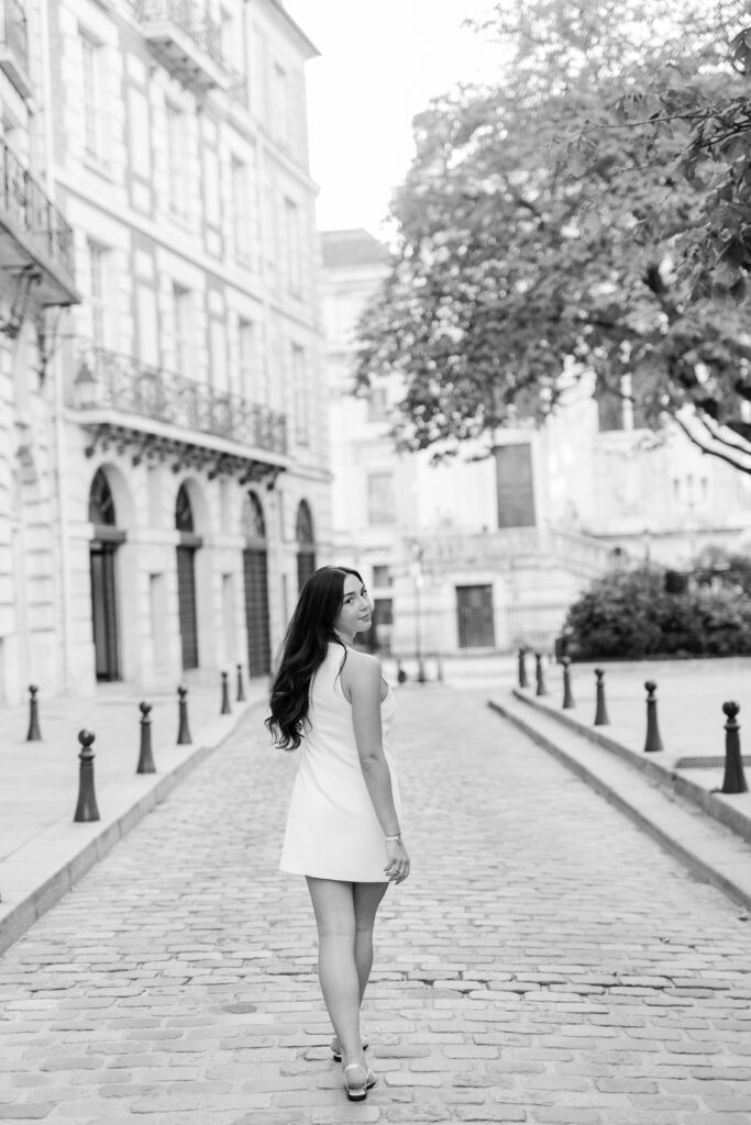Black and white portrait of young woman walking ion Paris by Katie Donnelly Photography