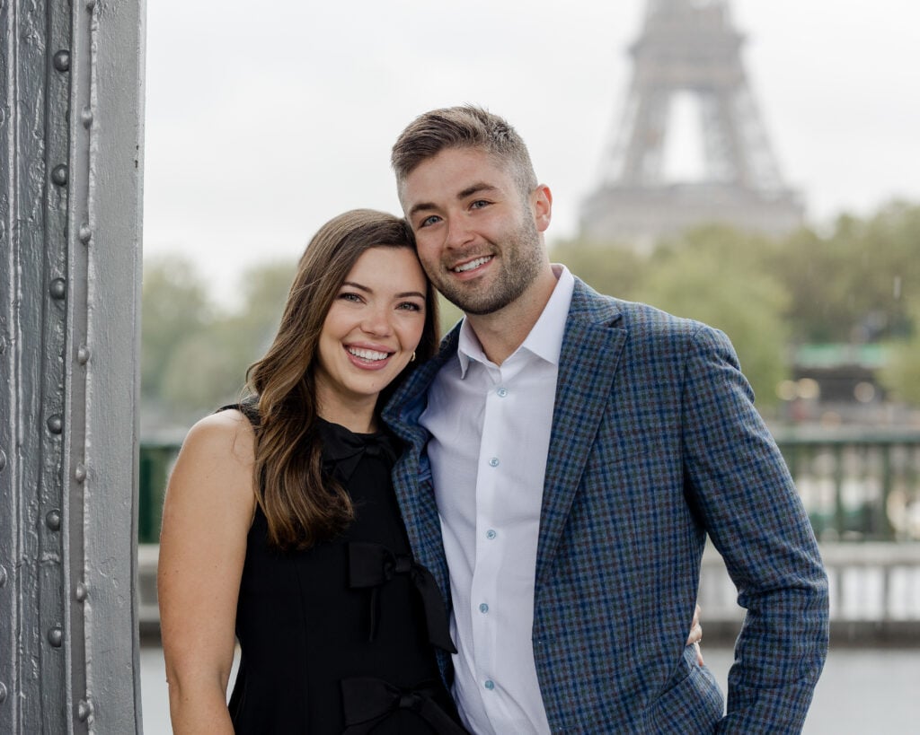 Portrait of young couple smiling in front of Eiffel Tower by Katie Donnelly Photography