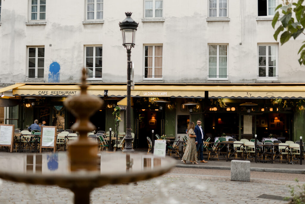 Couple standing in a Parisian square, captured by Paris photographer