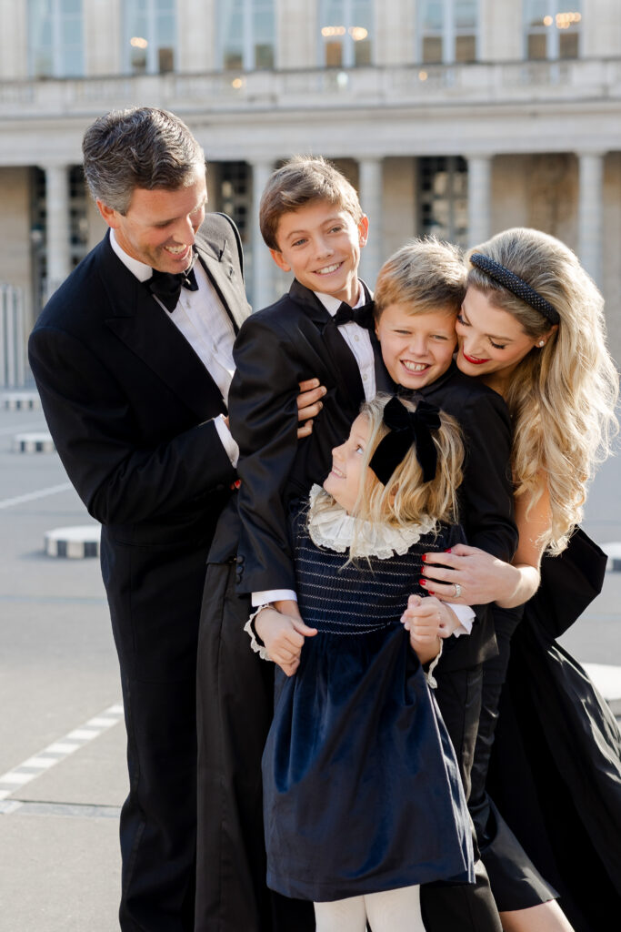 Portrait of family dressed in black and white smiling at Palais Royal in Paris by Katie Donnelly Photography