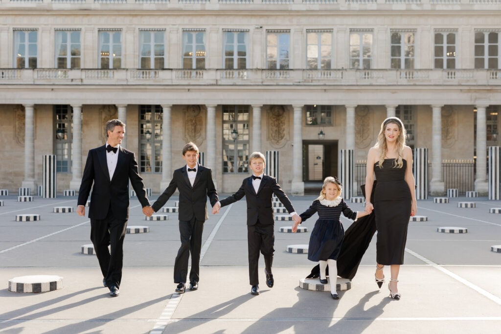 Vibrant family portrait holding hands in Paris