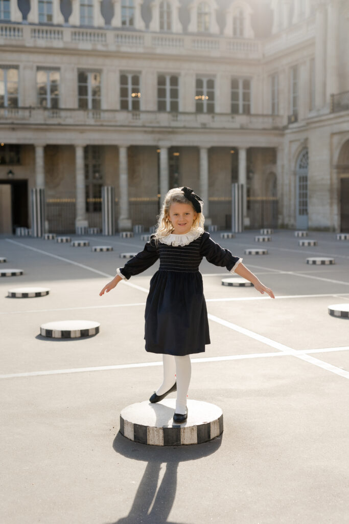 Portrait of young girl at Palais Royal in Paris - dressed in French style by Katie Donnelly Photography