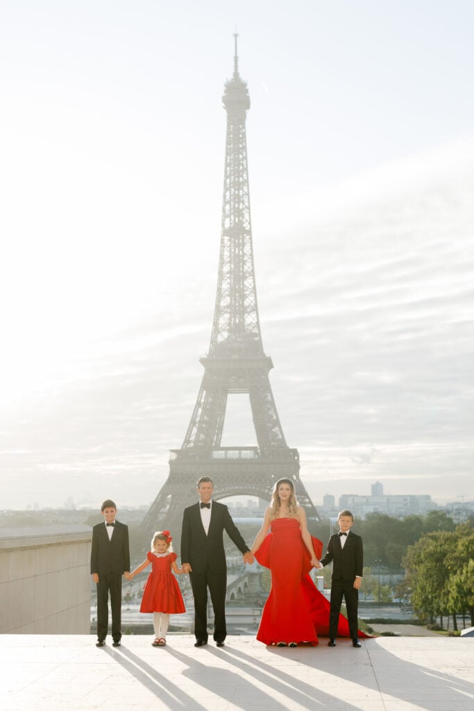 Portrait of family posing in front of Eiffel Tower: black tie family trocadéro photoshoot by Katie Donnelly Photography