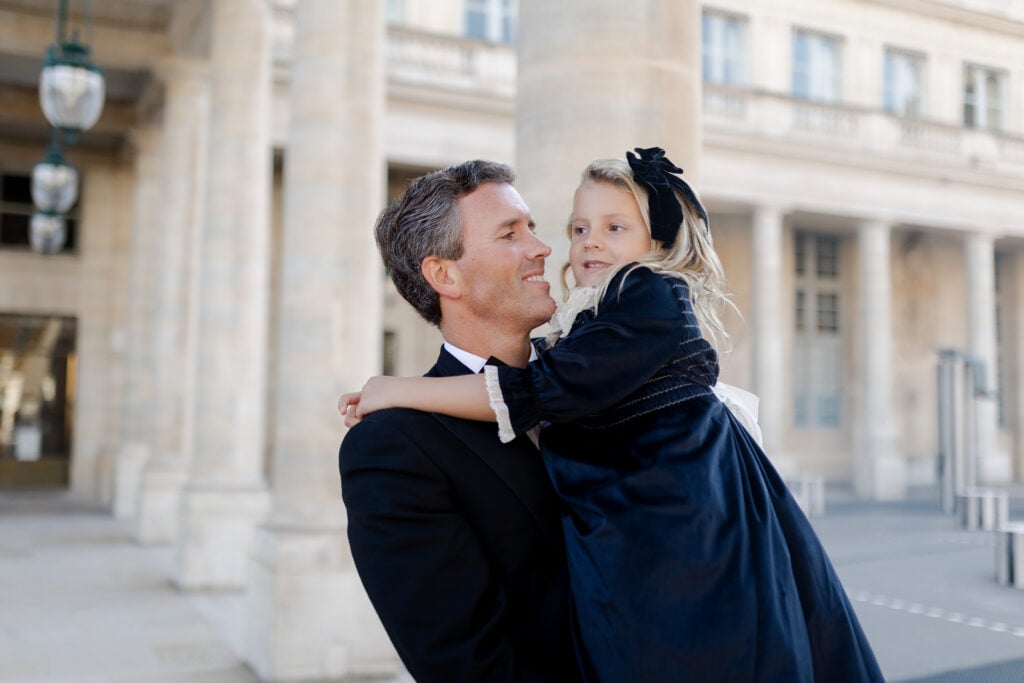 Portrait of dad holding daughter at Palais Royal in Paris: black tie family photoshoot by Katie Donnelly Photography