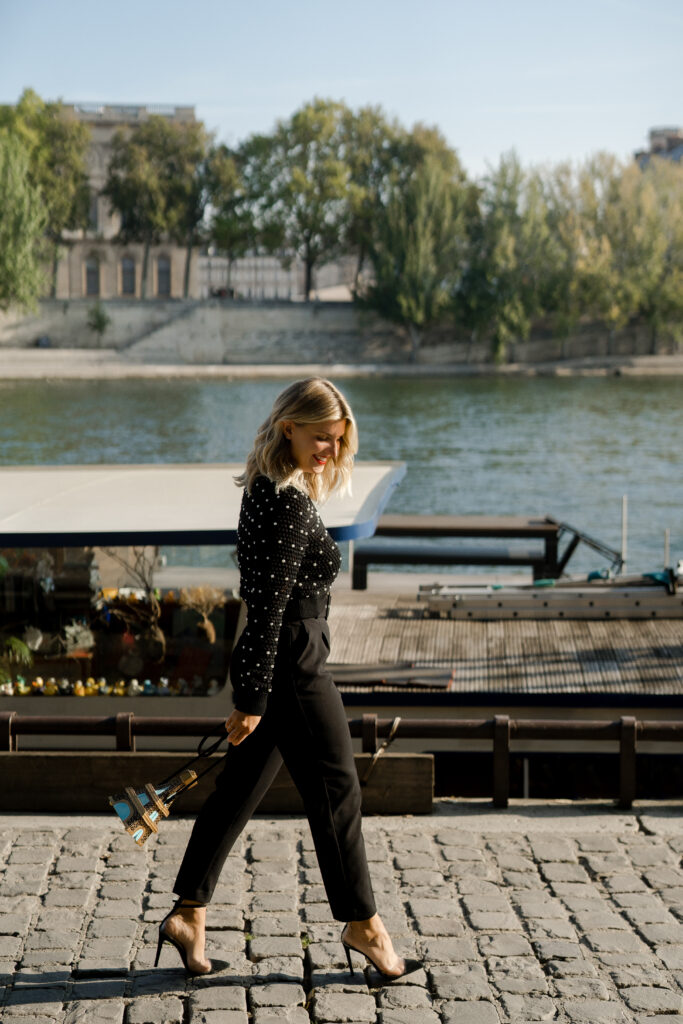Elegant woman walking near the river in Paris