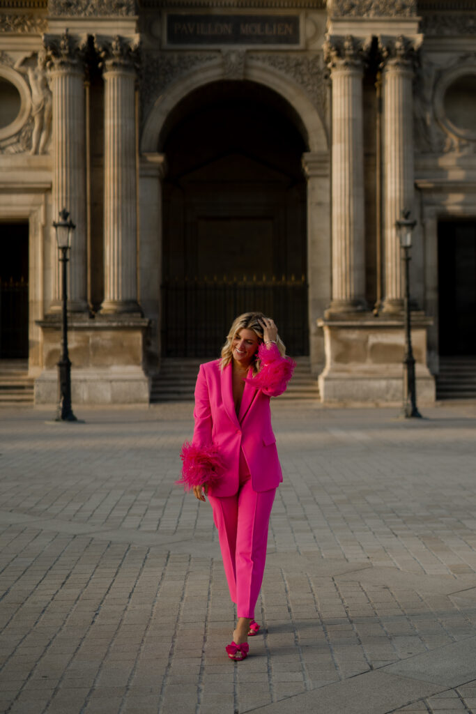 Elegant woman strolling by the Louvre in Paris