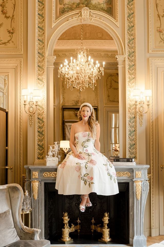Portrait of woman sitting on mantle at Hotel de Crillon in Paris by Katie Donnelly Photography