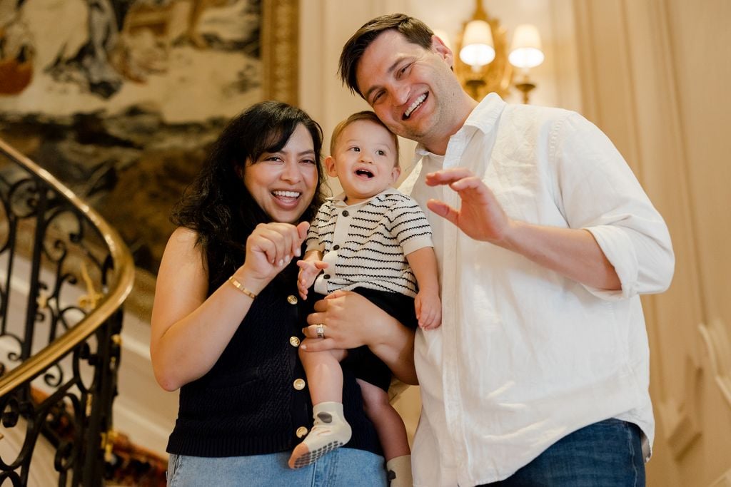 Portrait of family smiling on grand staircase at the Ritz Hotel in Paris by Katie Donnelly Photography