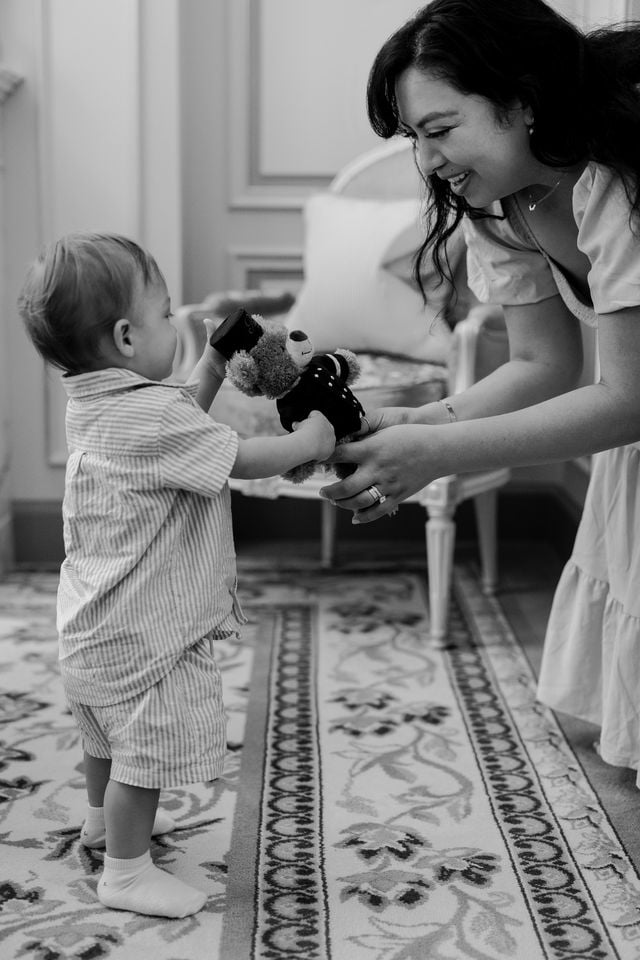 Black and white portrait of mother with her son and a teddy bear at the Ritz Hotel in Paris by Katie Donnelly Photography