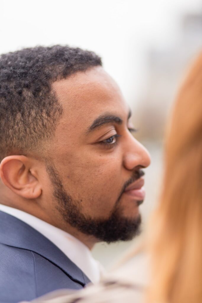 Close-up profile portrait of a man looking at his partner on a Paris street