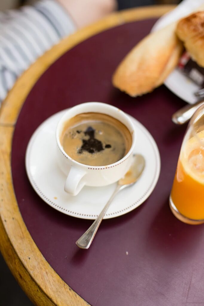 Coffee and a croissant on a café table in Paris