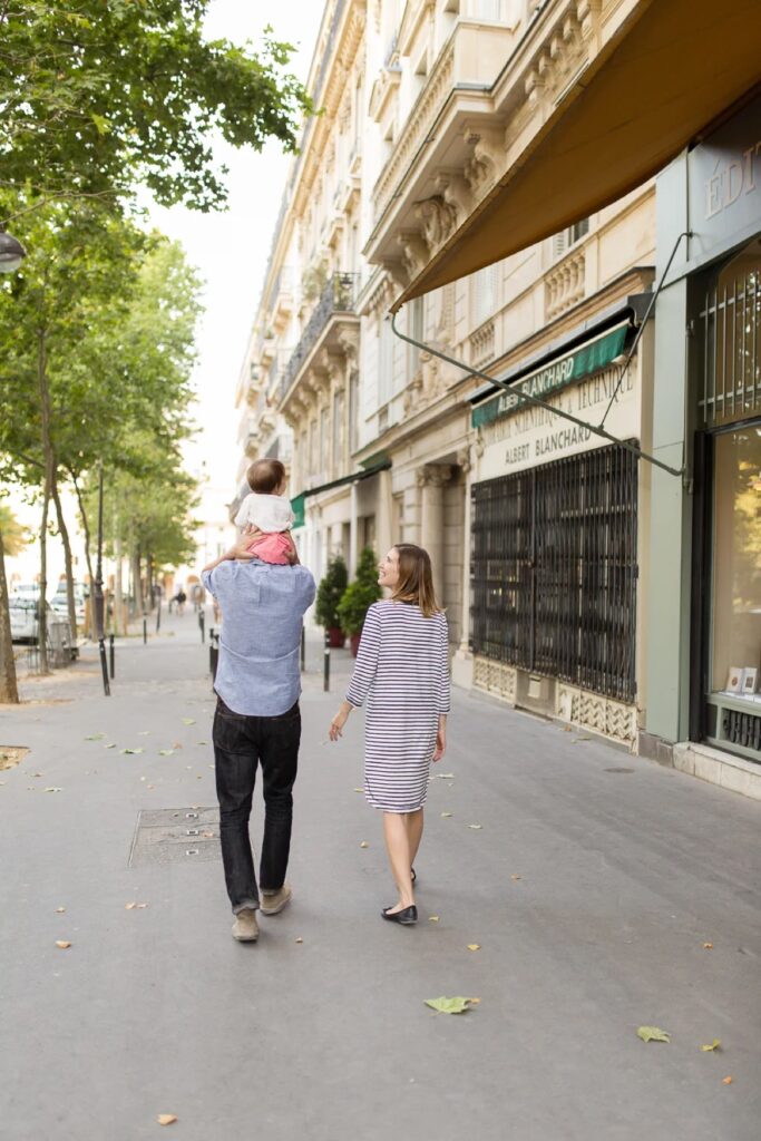 Family walking away down a Paris street after their family photoshoot