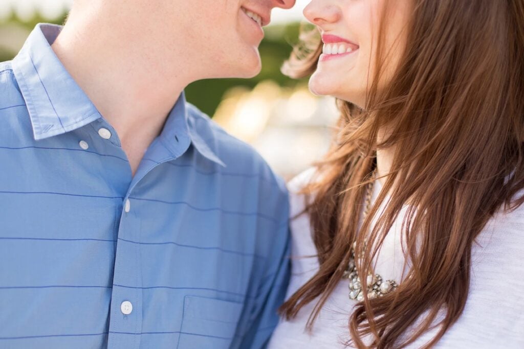 Close-up of a couple smiling nose to nose, photographed from very close