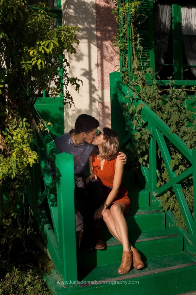 Couple kissing on the green steps of Claude Monet's house in Giverny