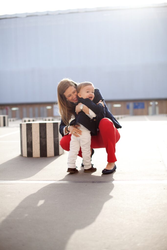 Mother hugging her toddler son among the striped columns of the Palais Royal
